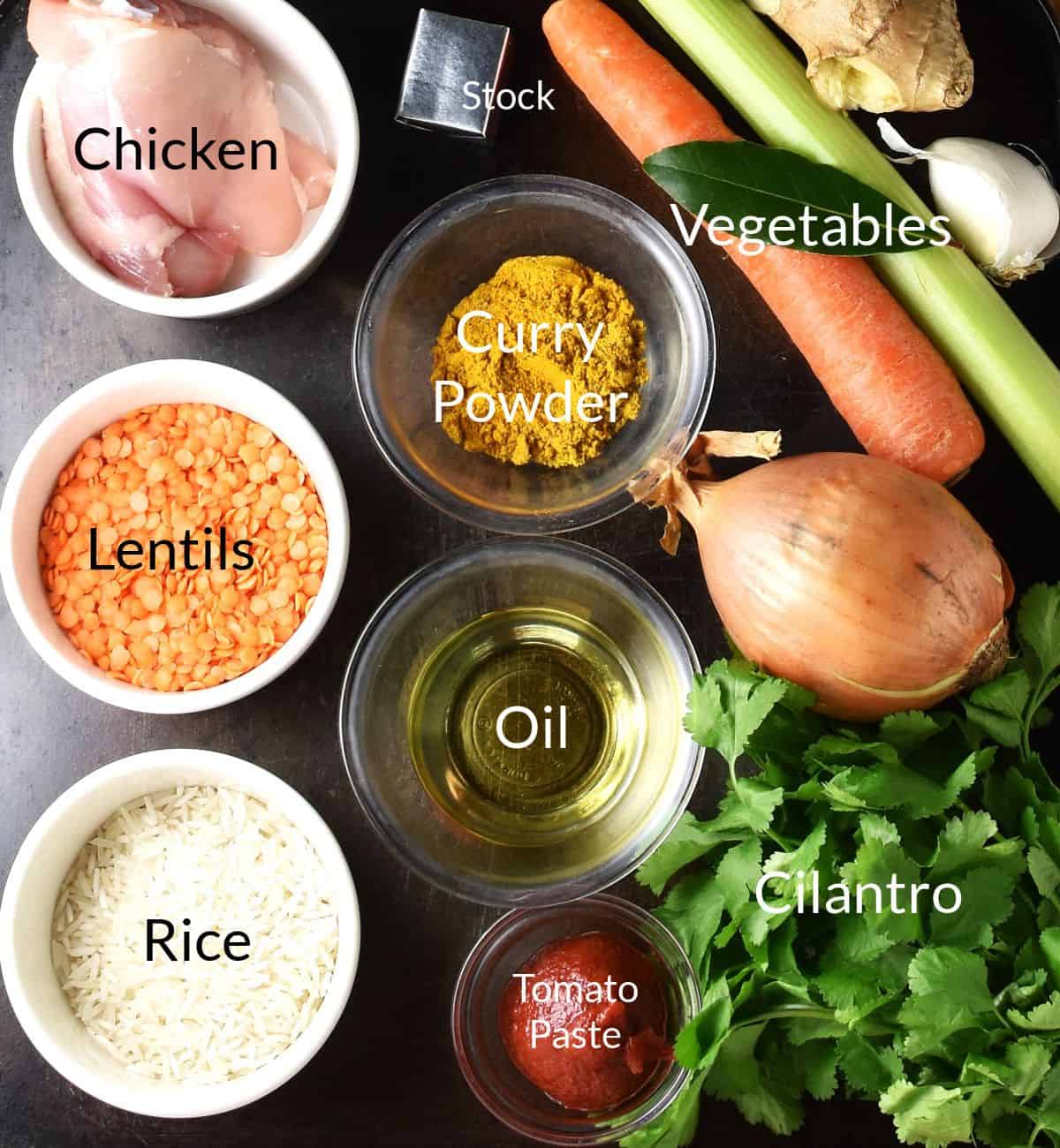 Ingredients for making chicken mulligatawny soup in individual dishes.