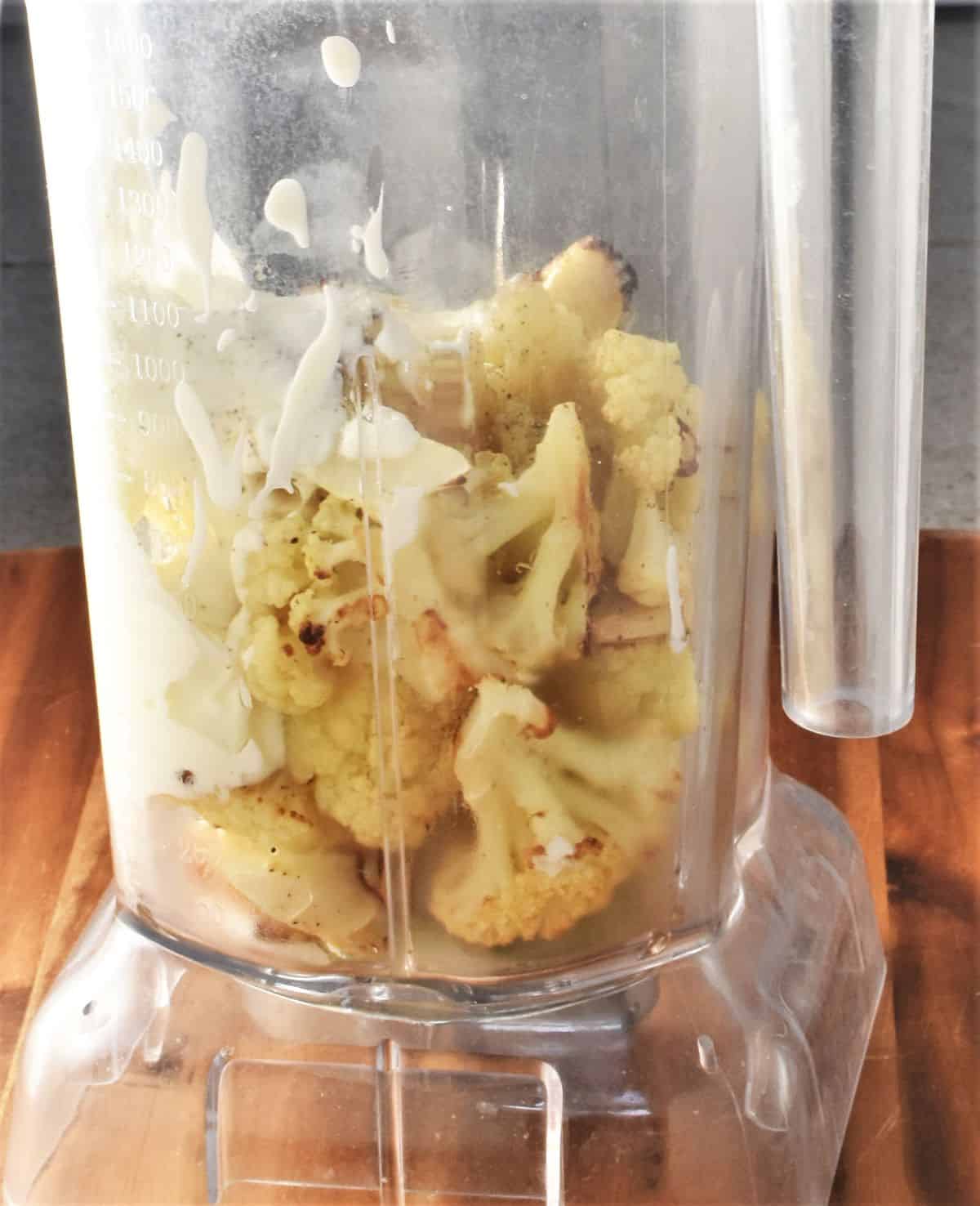 Cauliflower chunks and yogurt in tall blender.