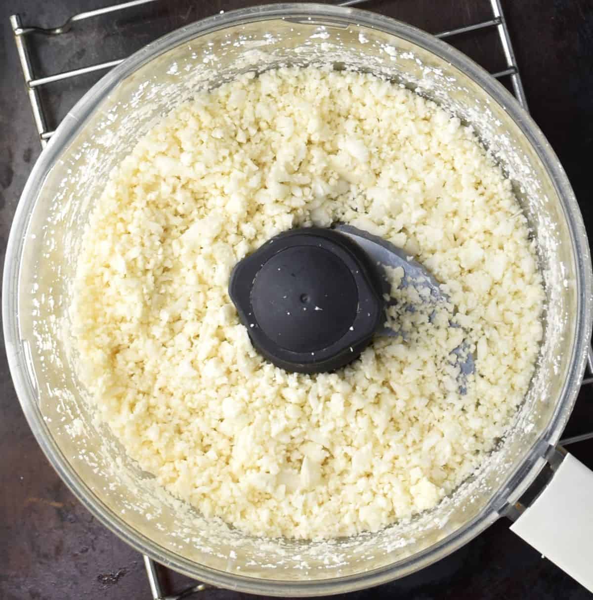 Cauliflower rice in food processor bowl.