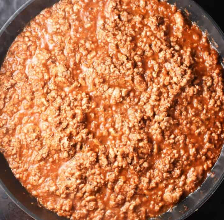 Ground meat mixture in tomato sauce in large pan.