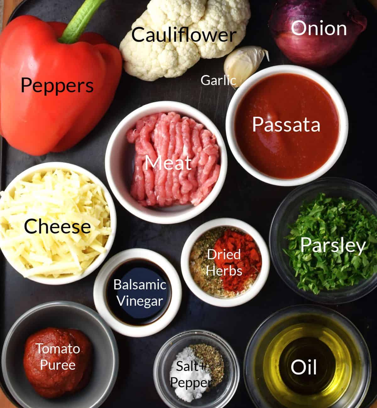 Ingredients for making cauliflower stuffed peppers in individual dishes.