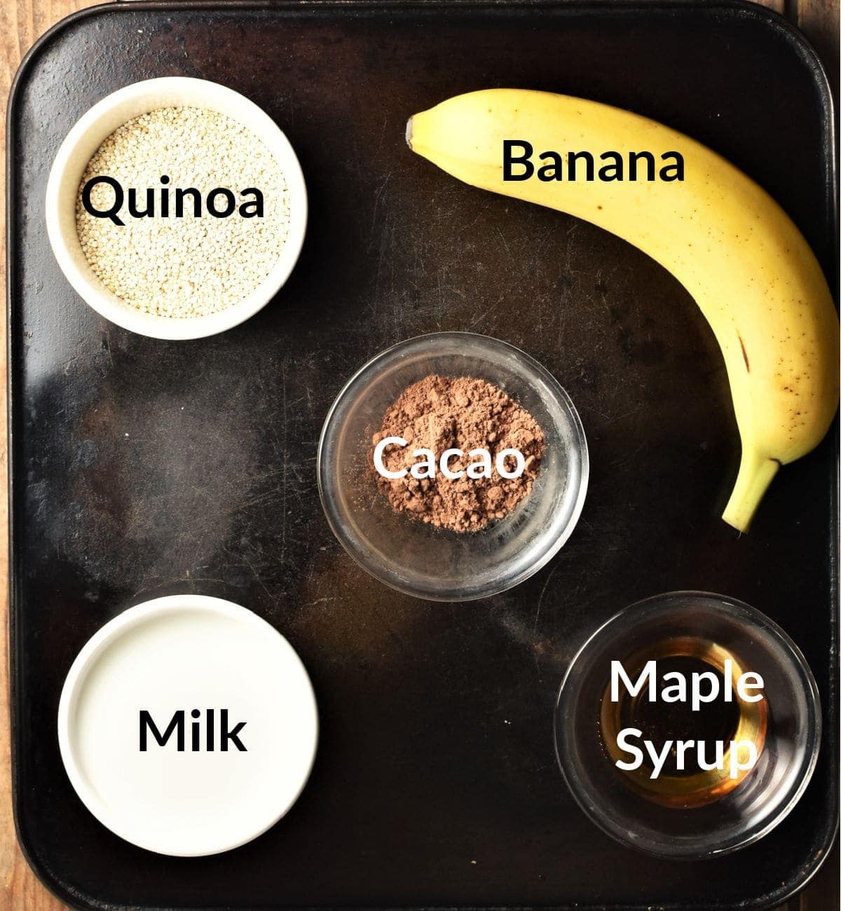 Quinoa porridge ingredients in individual dishes.