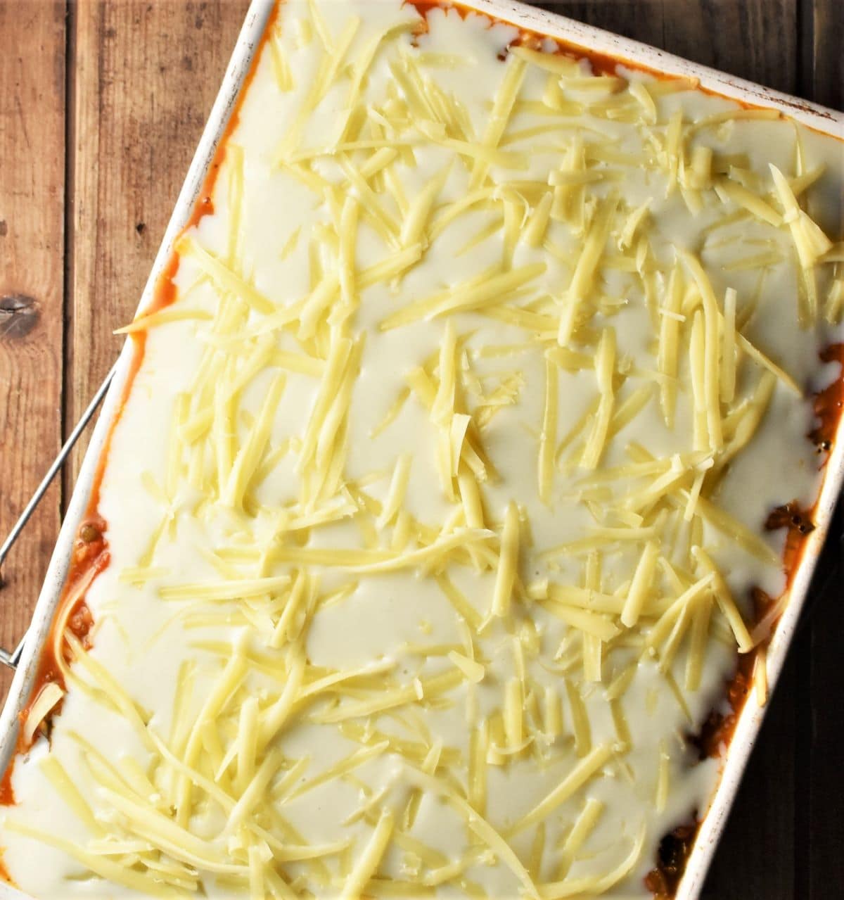 Lasagna with bechamel and grated cheese on top.