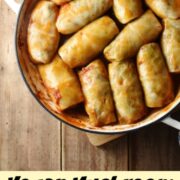 Top down view of cabbage rolls inside large white dish.