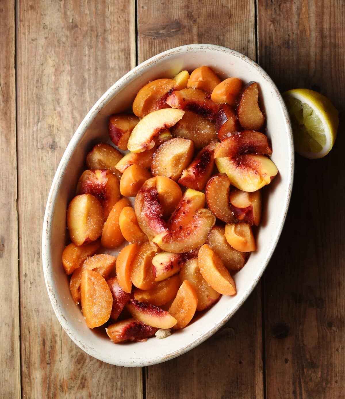 Peach wedges inside white oval dish.