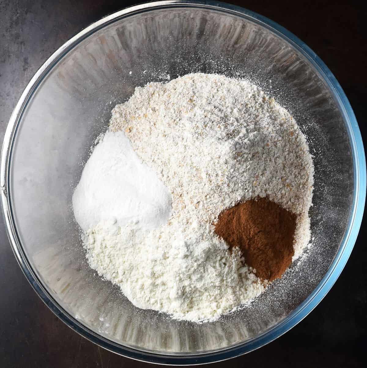 Dry ingredients for muffins in glass bowl.