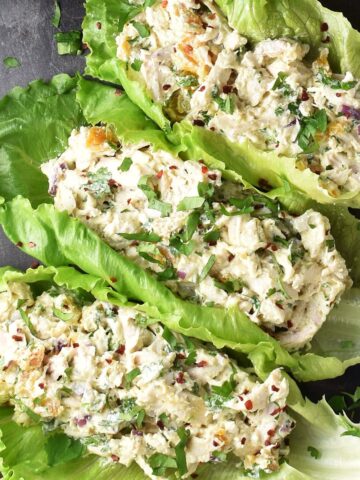 Top down view of chicken cottage cheese salad in lettuce leaves.