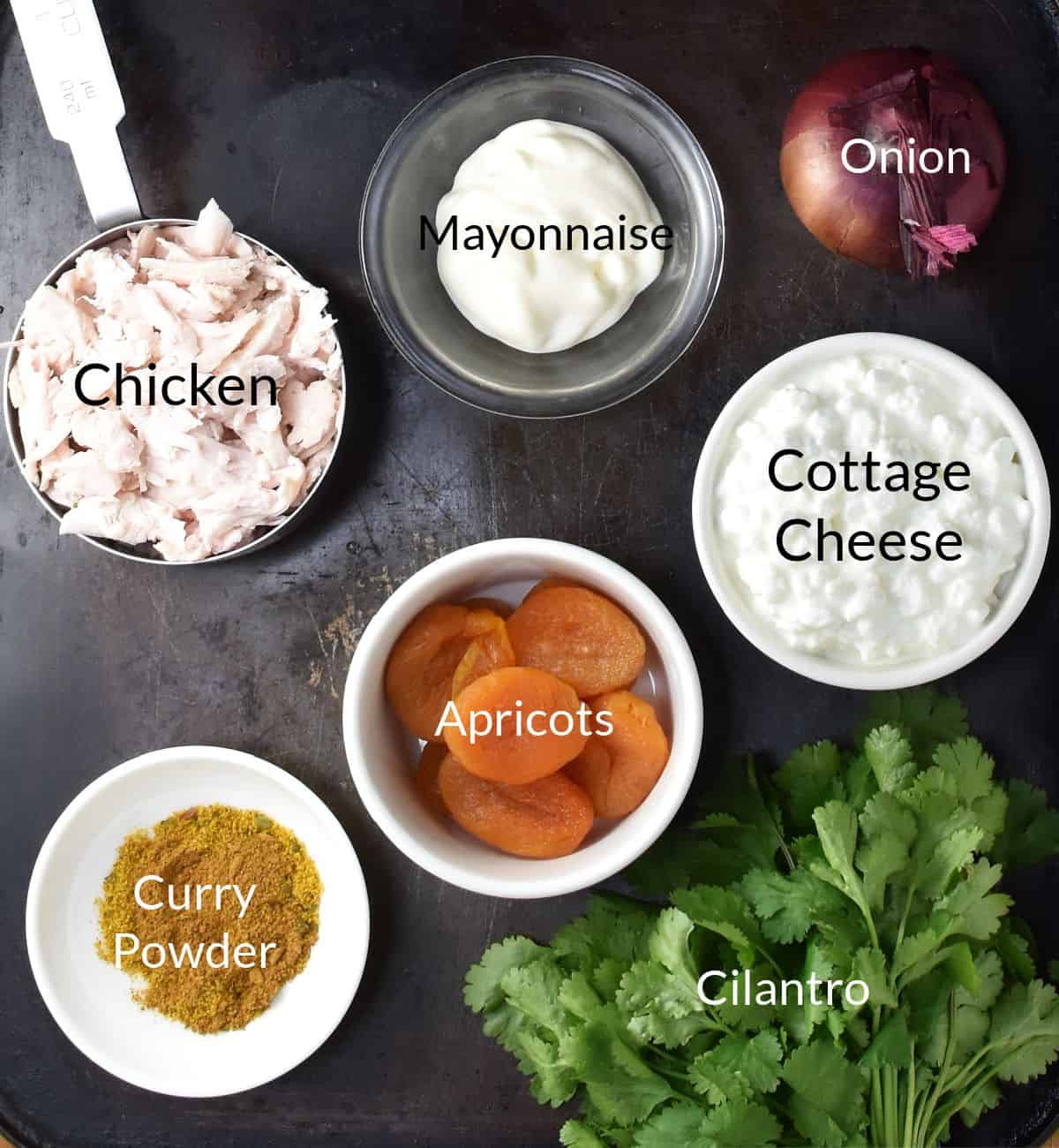 Ingredients for making cottage cheese chicken protein salad in individual dishes.