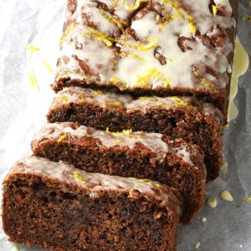 Side view of sliced persimmon bread on parchment.