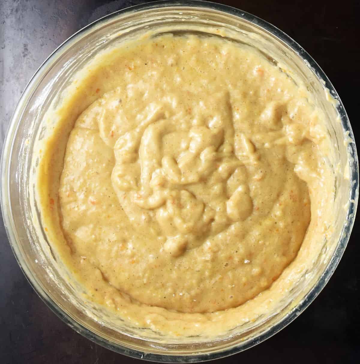 Thick persimmon bread batter in glass bowl.