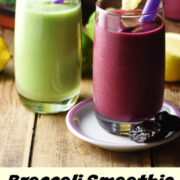 Side view of purple and green smoothies in glasses with purple straws.