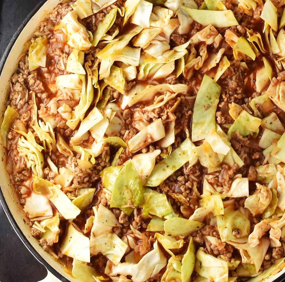 Unstuffed cabbage with meat and rice in skillet.