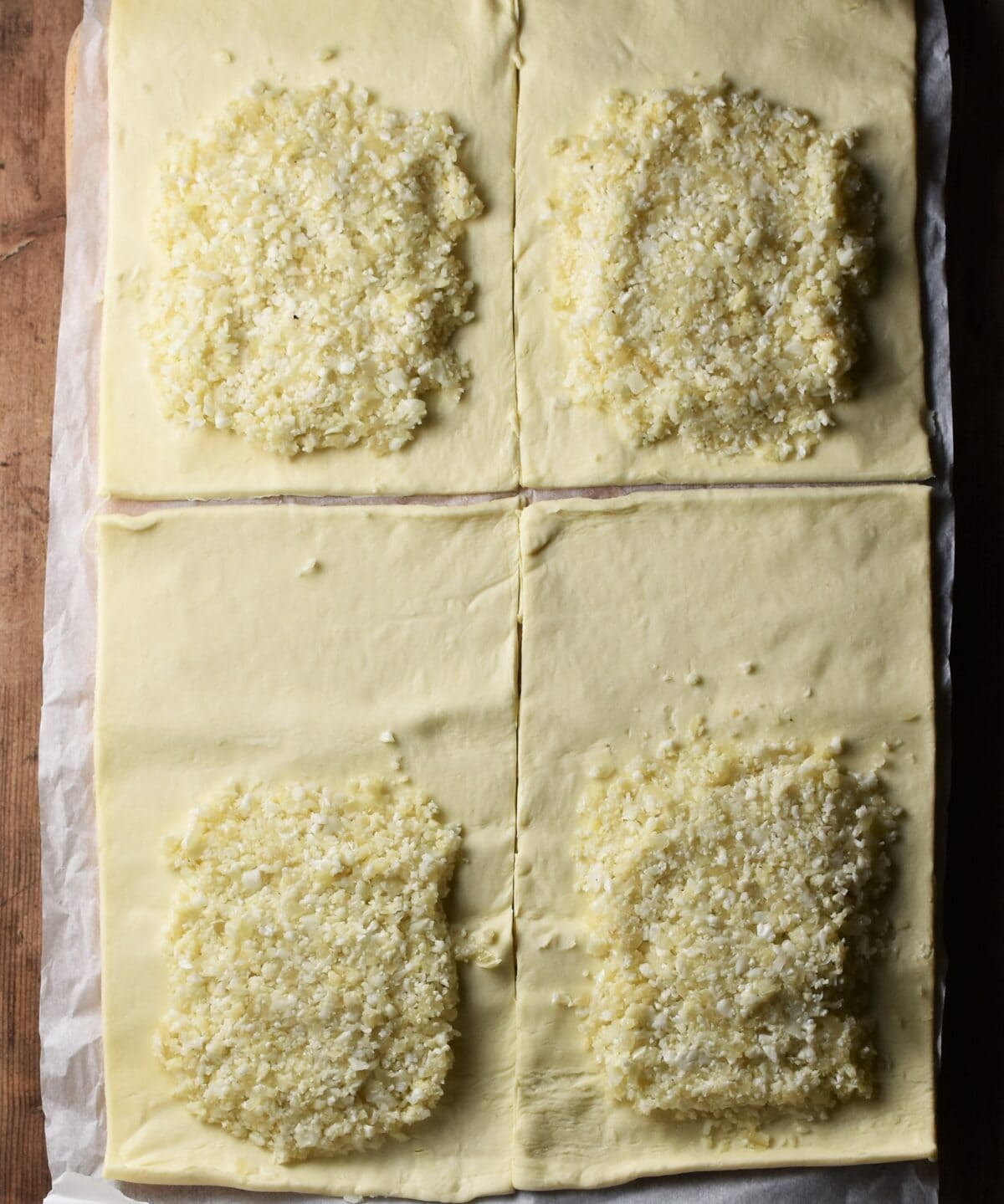 Cauliflower mixture on top of 4 rectangular pieces of pastry.