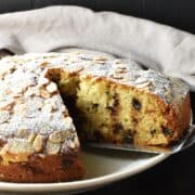 Side view of marzipan cake on white plate.