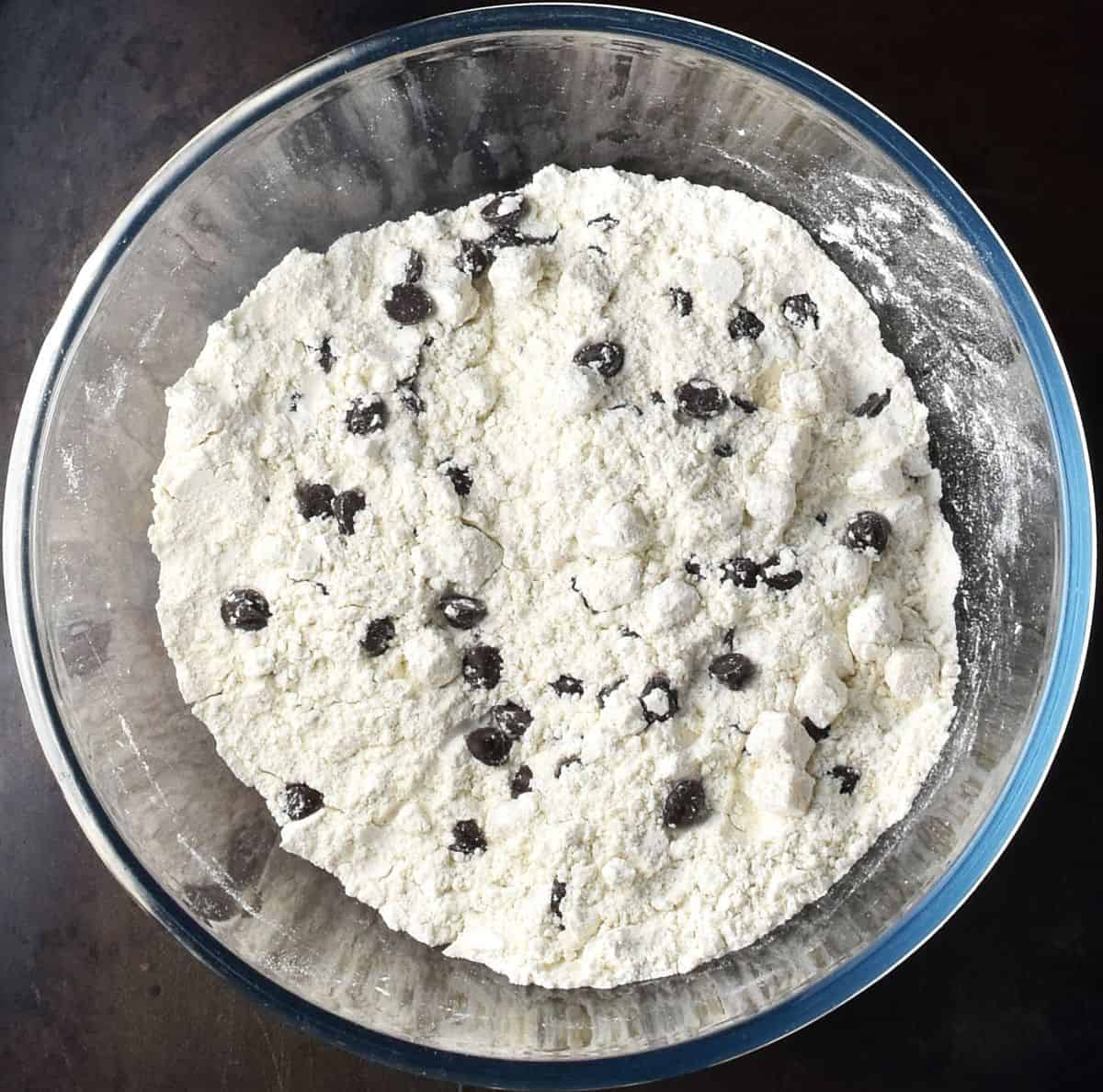 Top down view of flour mixture for marzipan cake in glass bowl.