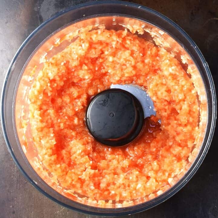 Finely chopped vegetables in blender bowl.