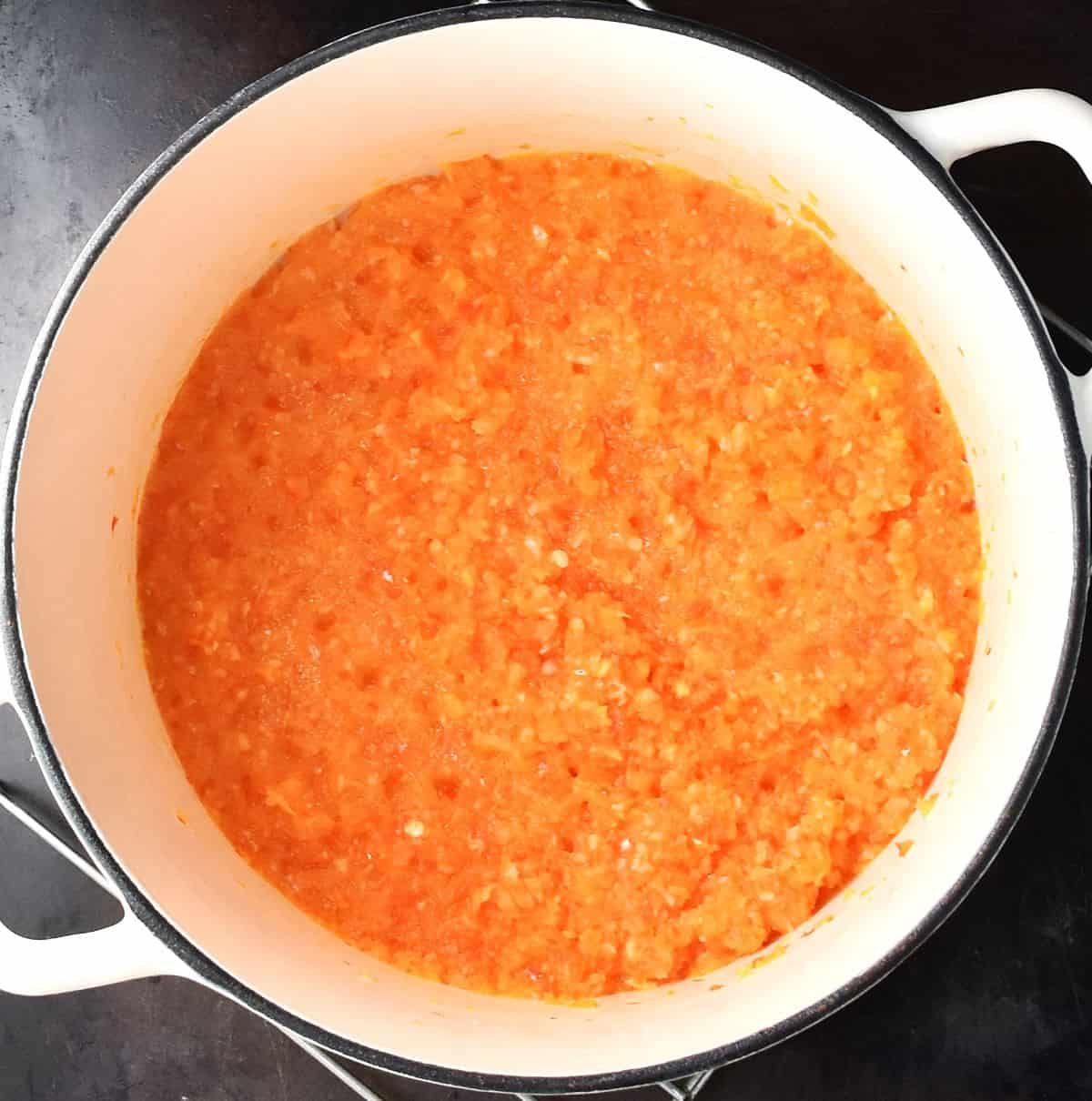 Cooking vegetables for beluga curry in white pot.