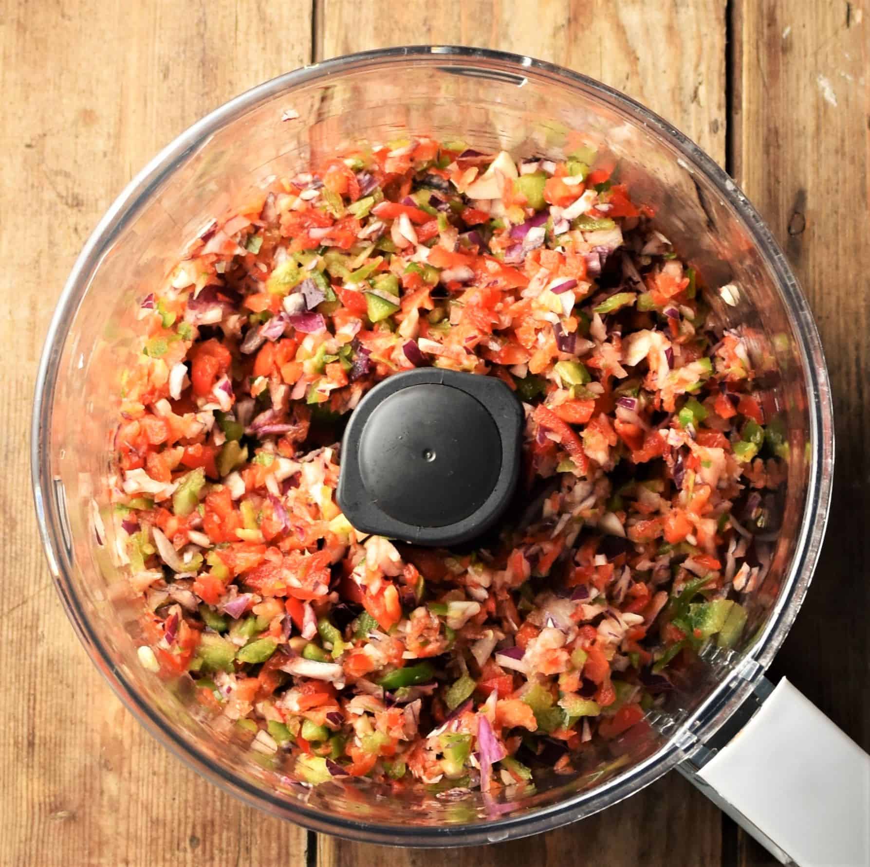 Finely chopped vegetables in blender bowl.