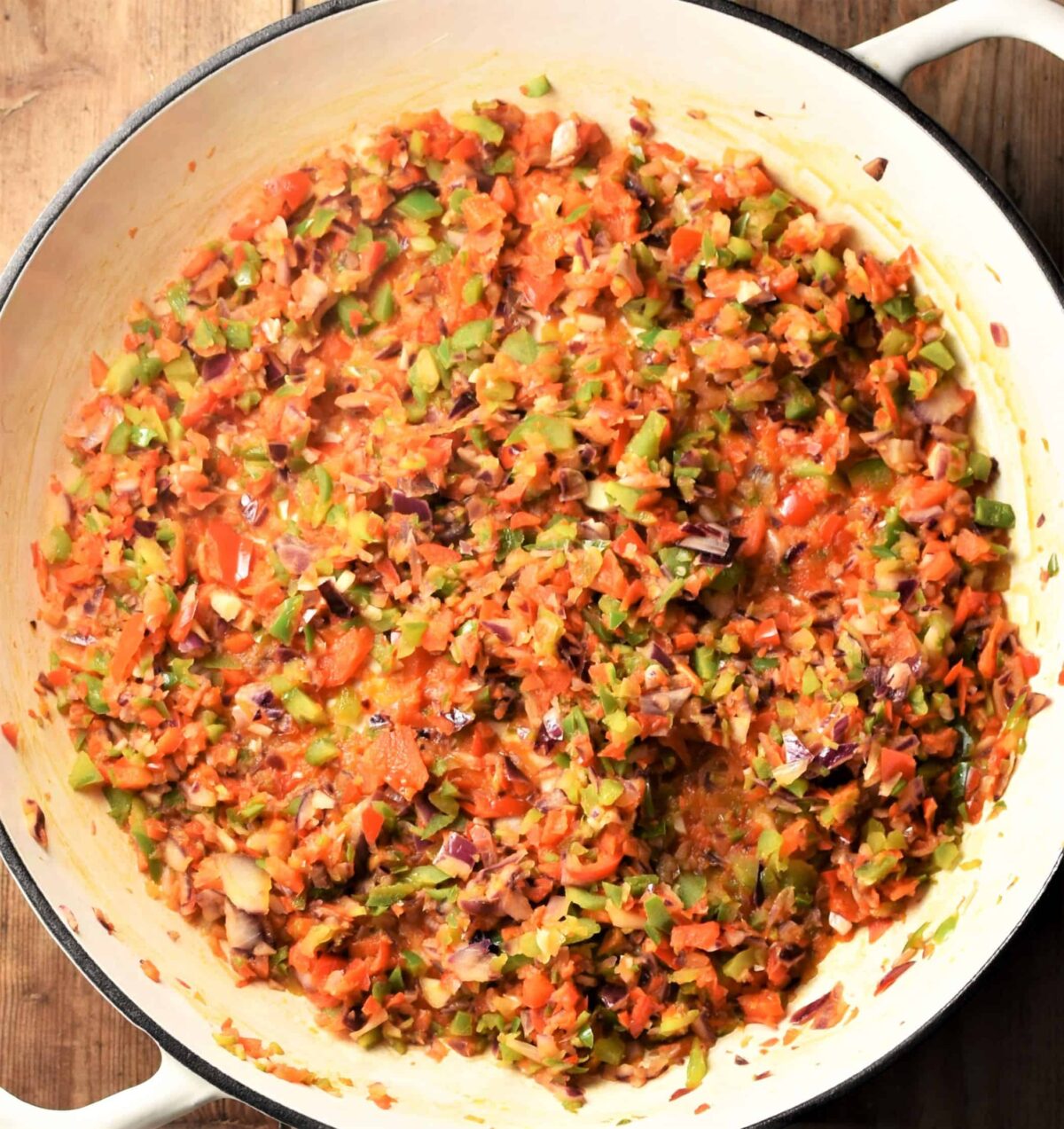 Ground meat and chopped vegetable mixture in large white pan.