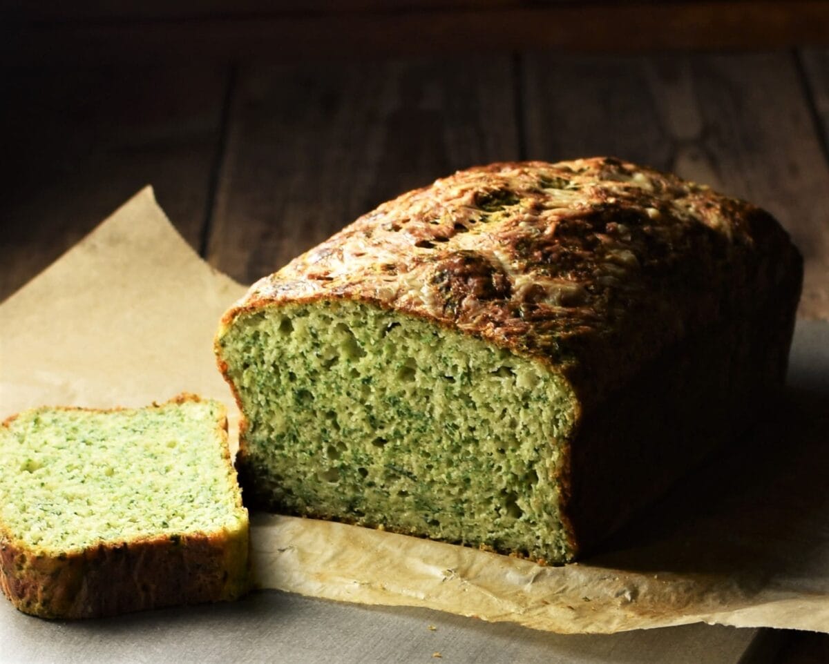 Side view of bread with spinach on top of parchment.