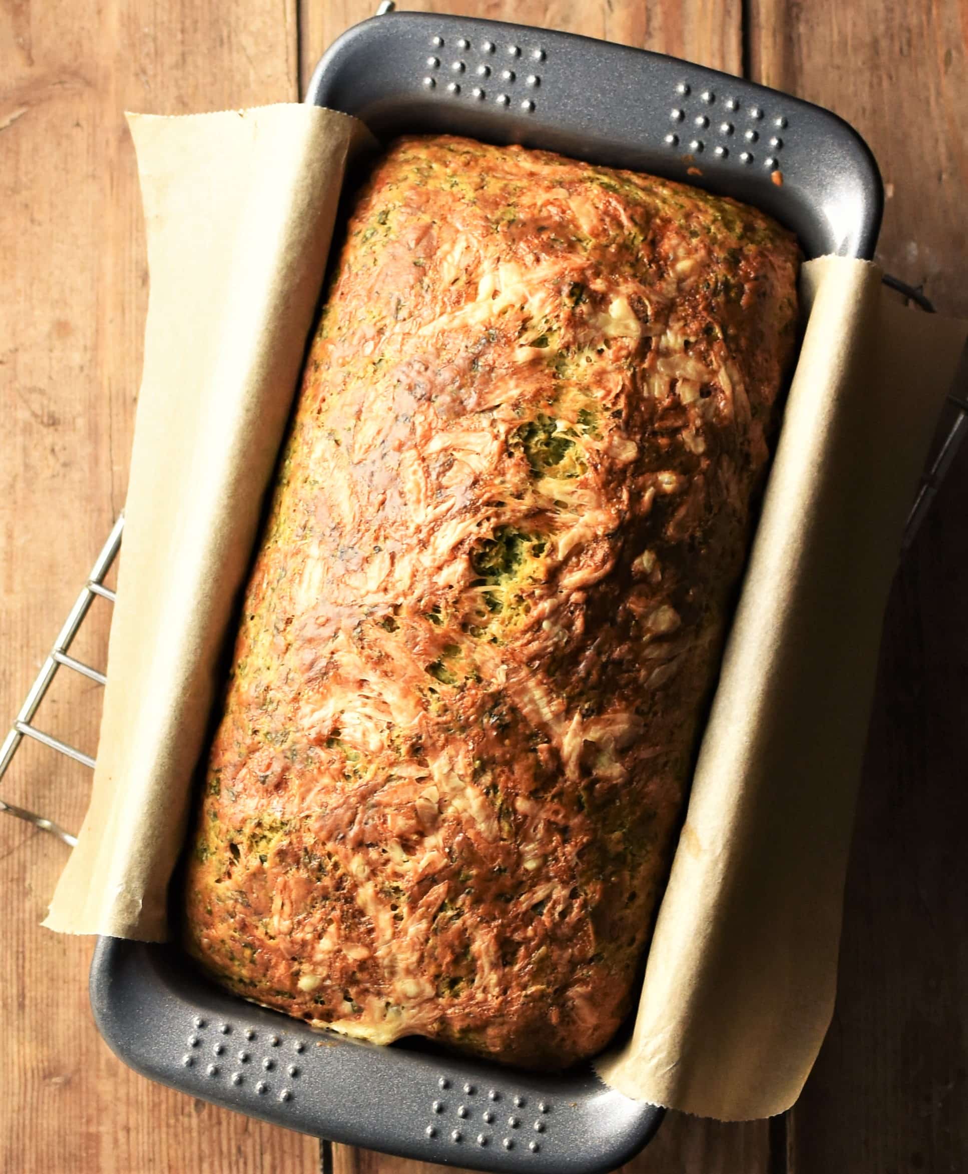 Top down view of baked bread in loaf pan.