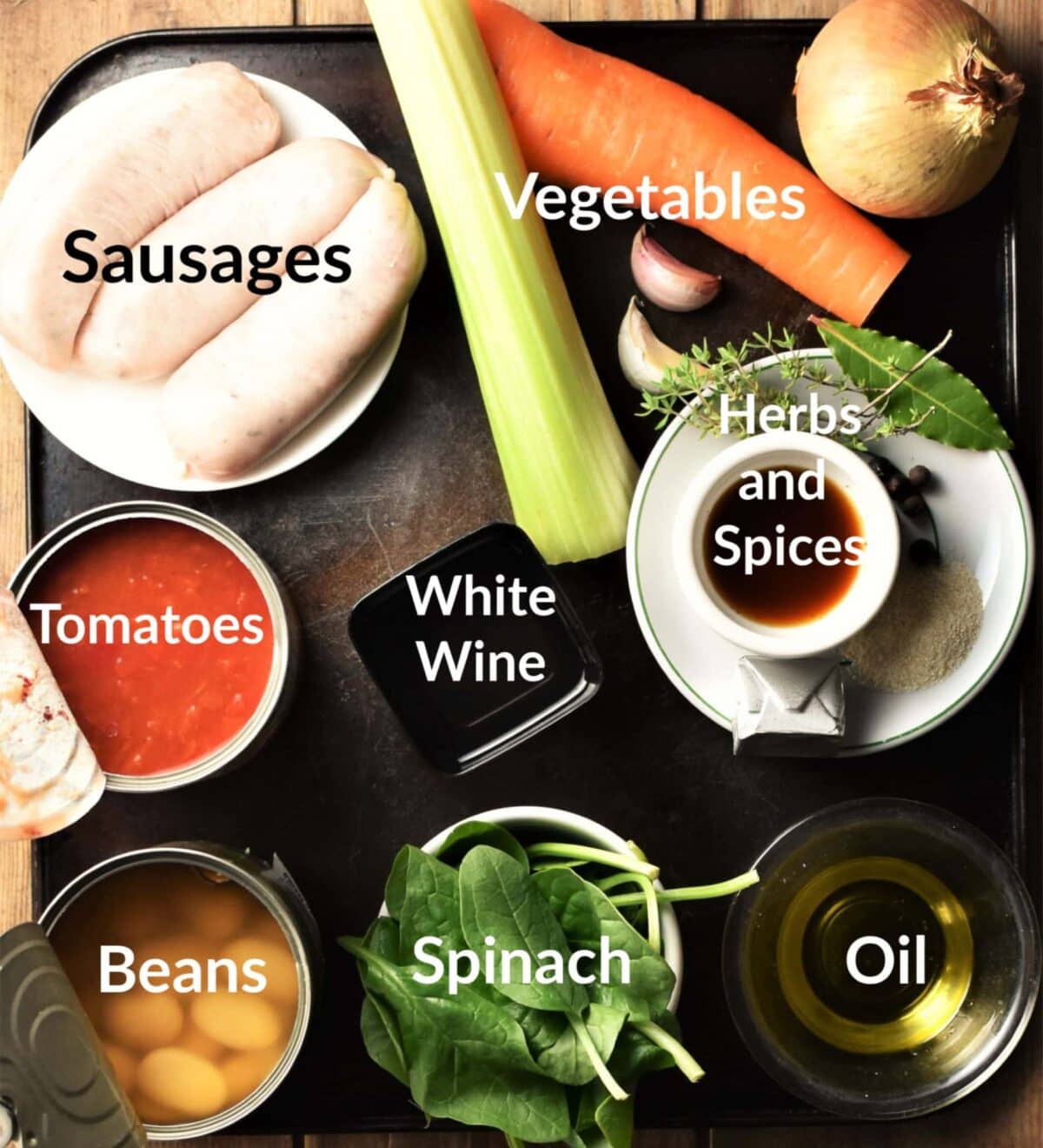 Sausage and bean casserole ingredients in individual dishes.