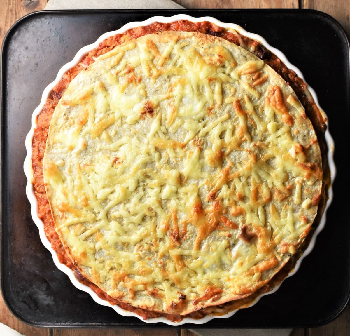 Tortilla bake with browned top in round pie dish.