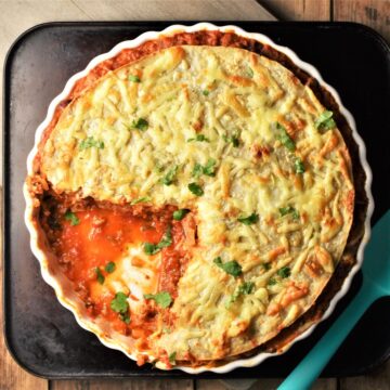 Cut tortilla bake in pie dish with sauce visible.