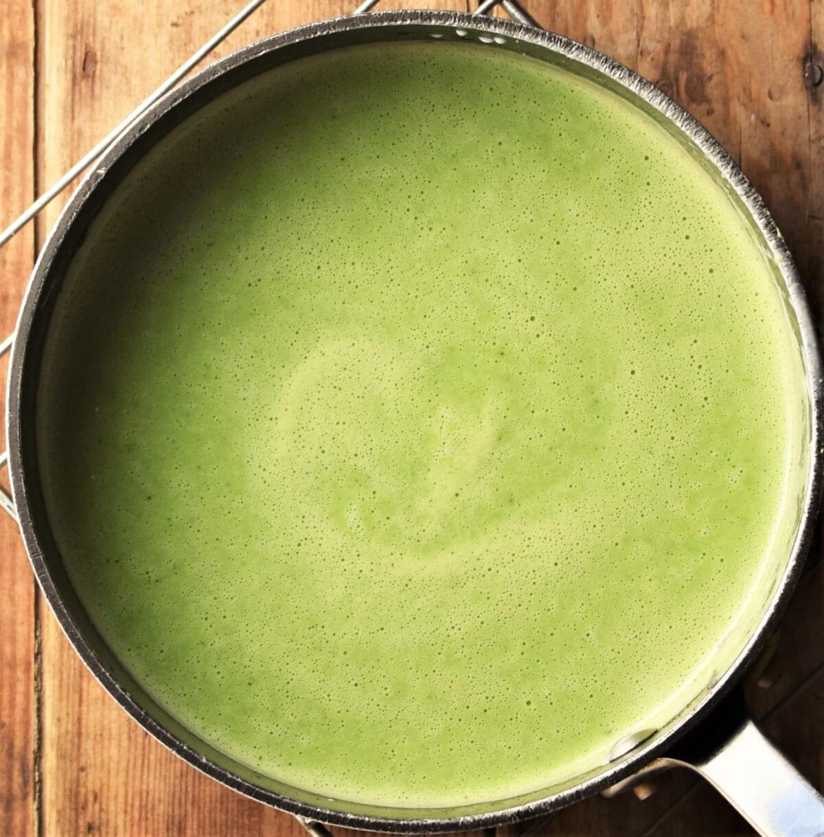 Creamy cucumber pea soup in pot.