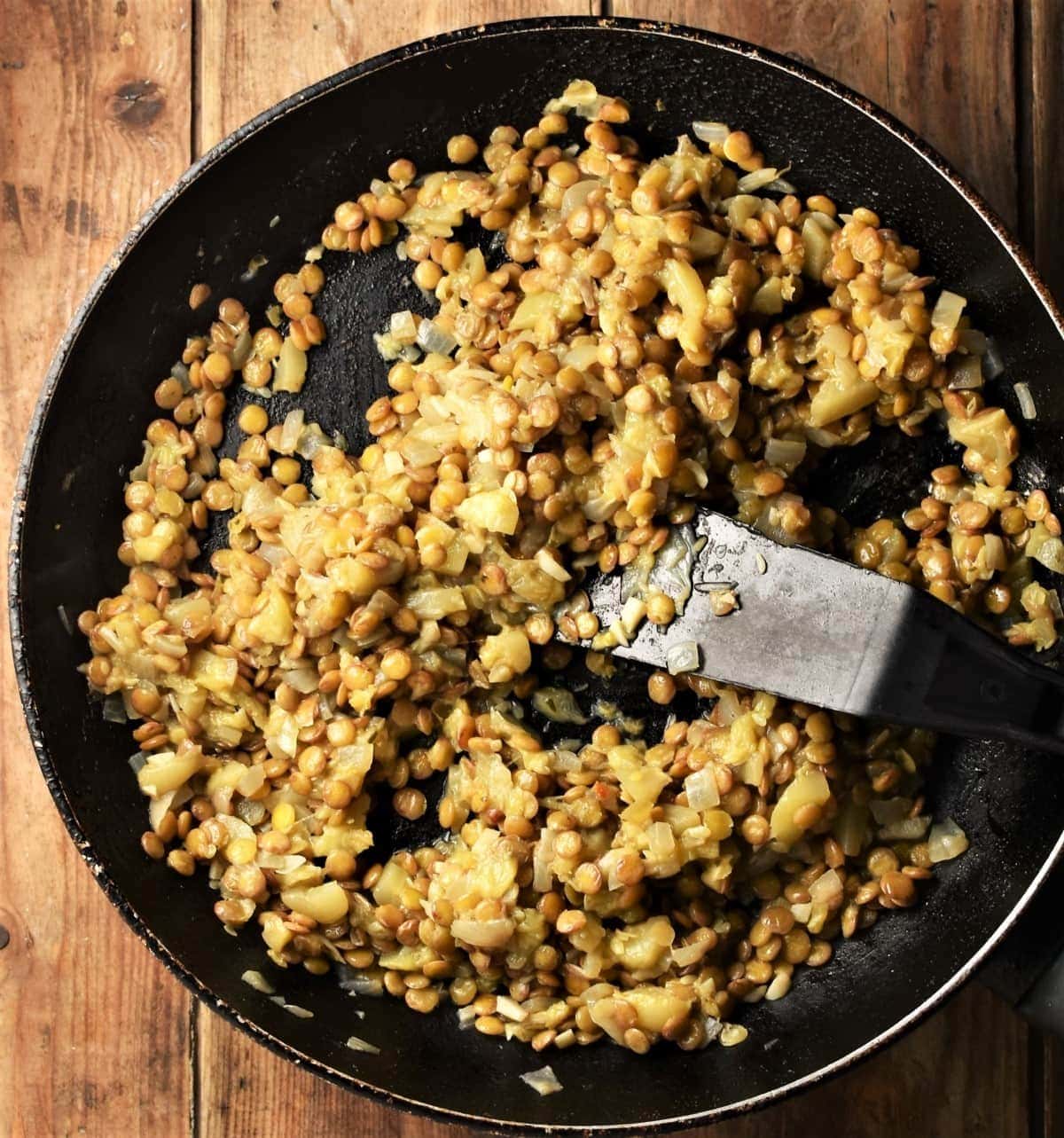 Lentil mixture in large pan with spatula.