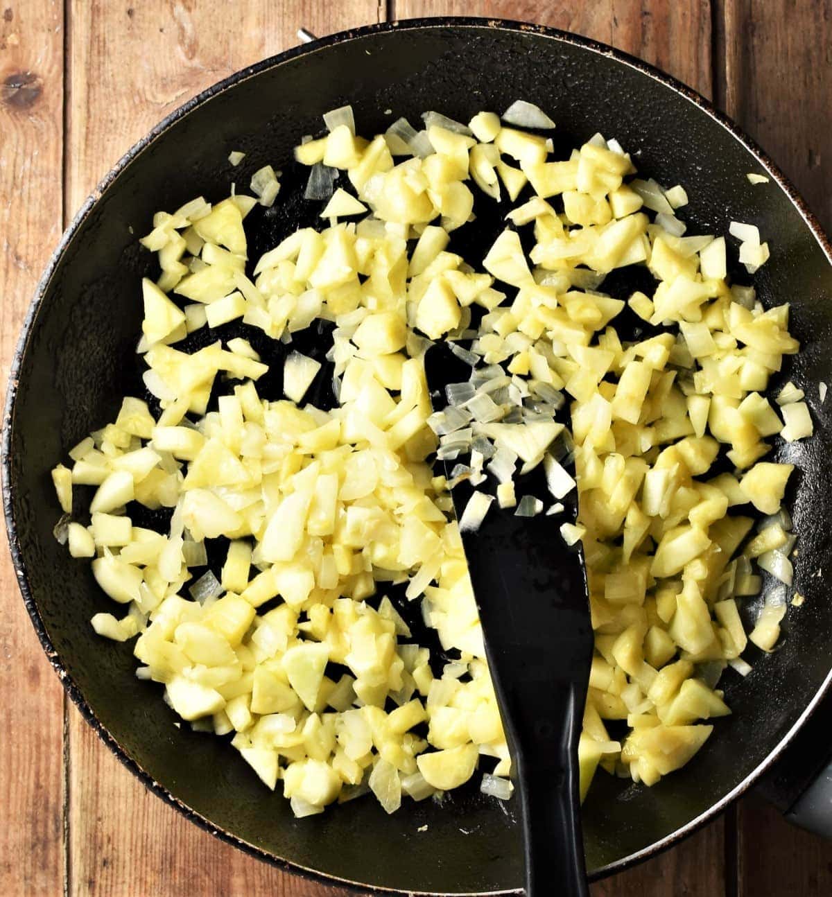Chopped vegetable mixture in large pan with spatula.