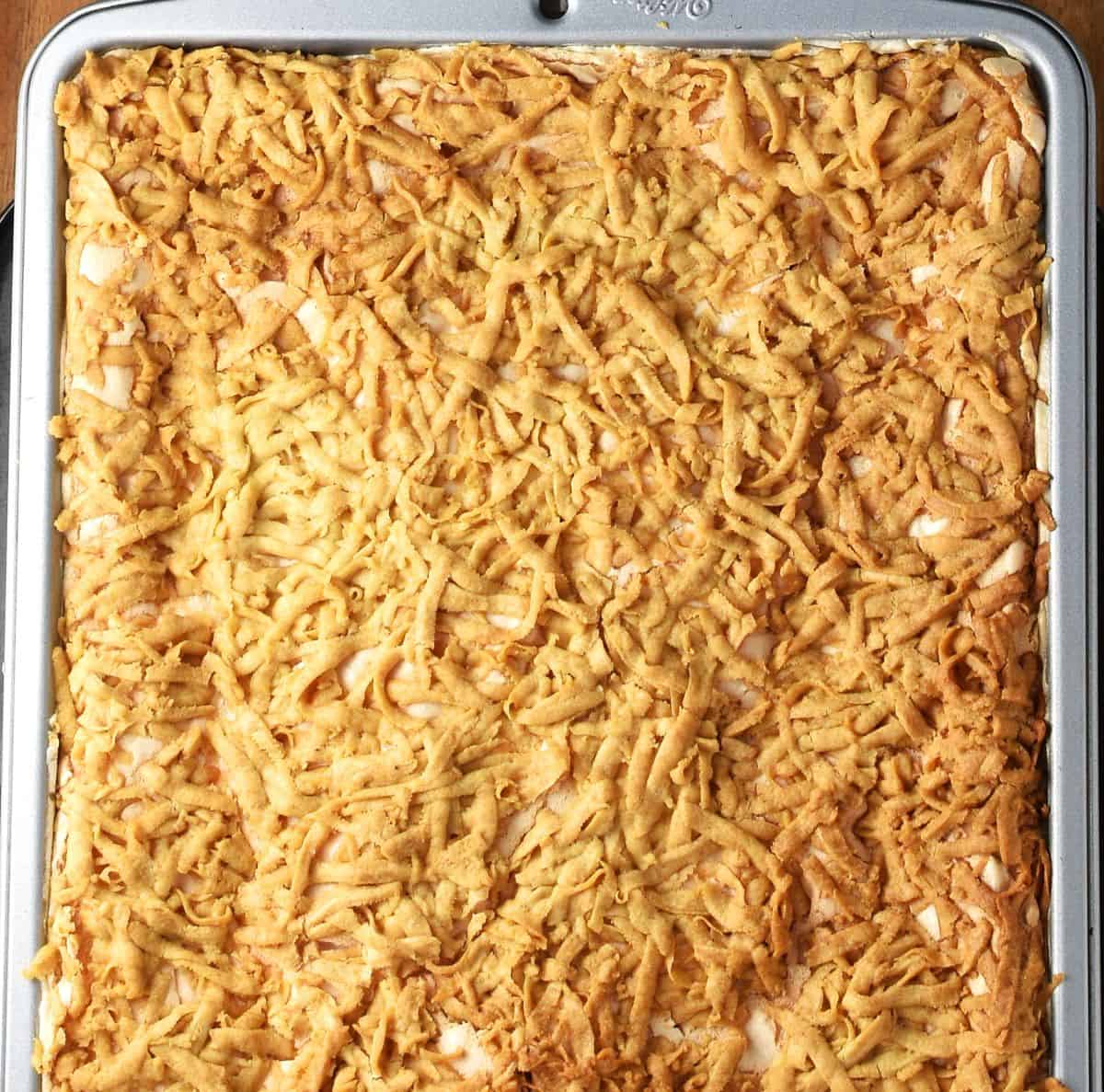 Baked Polish plesniak cake with crumb top in rectangular pan.