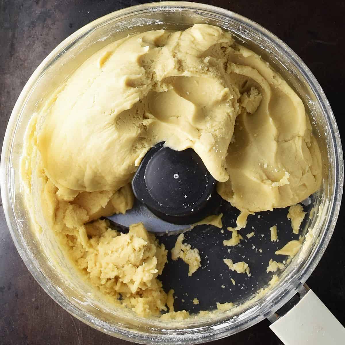 Top down view of pastry for plesniak cake in food processor bowl.