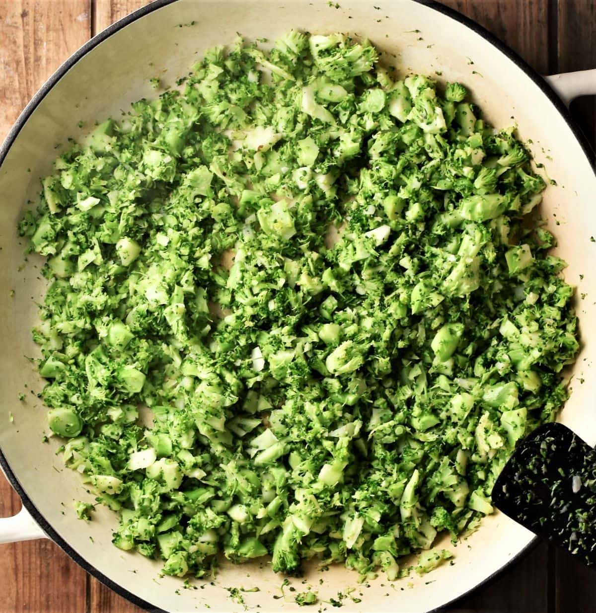 Broccoli rice in large shallow white pan.