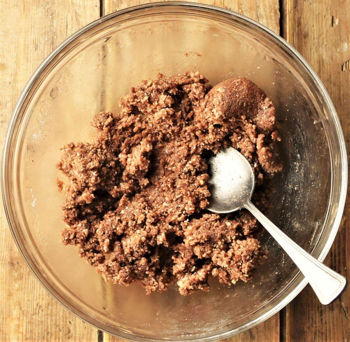 Cheesecake dessert base mixture in bowl with spoon.