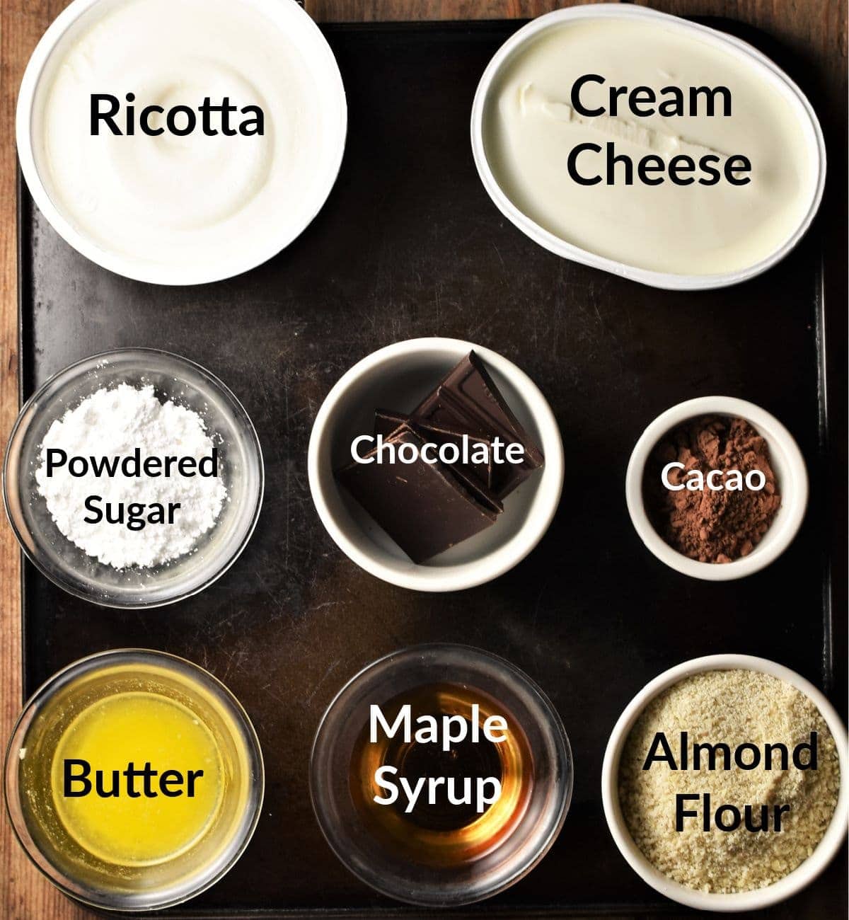 Cheesecake cups ingredients in individual dishes.