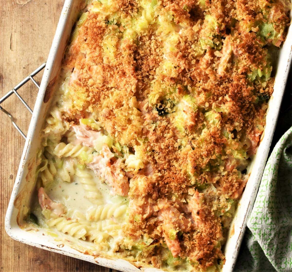 Top down view of creamy pasta and salmon bake with crispy topping.