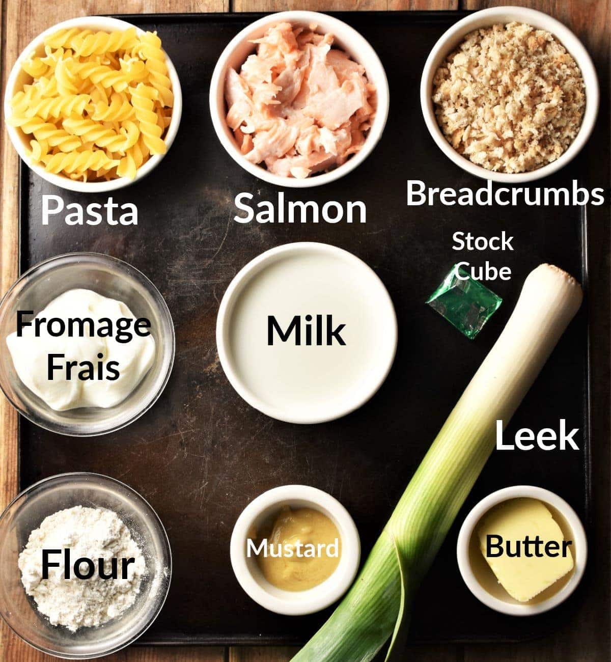 Ingredients for making salmon pasta bake in individual dishes.