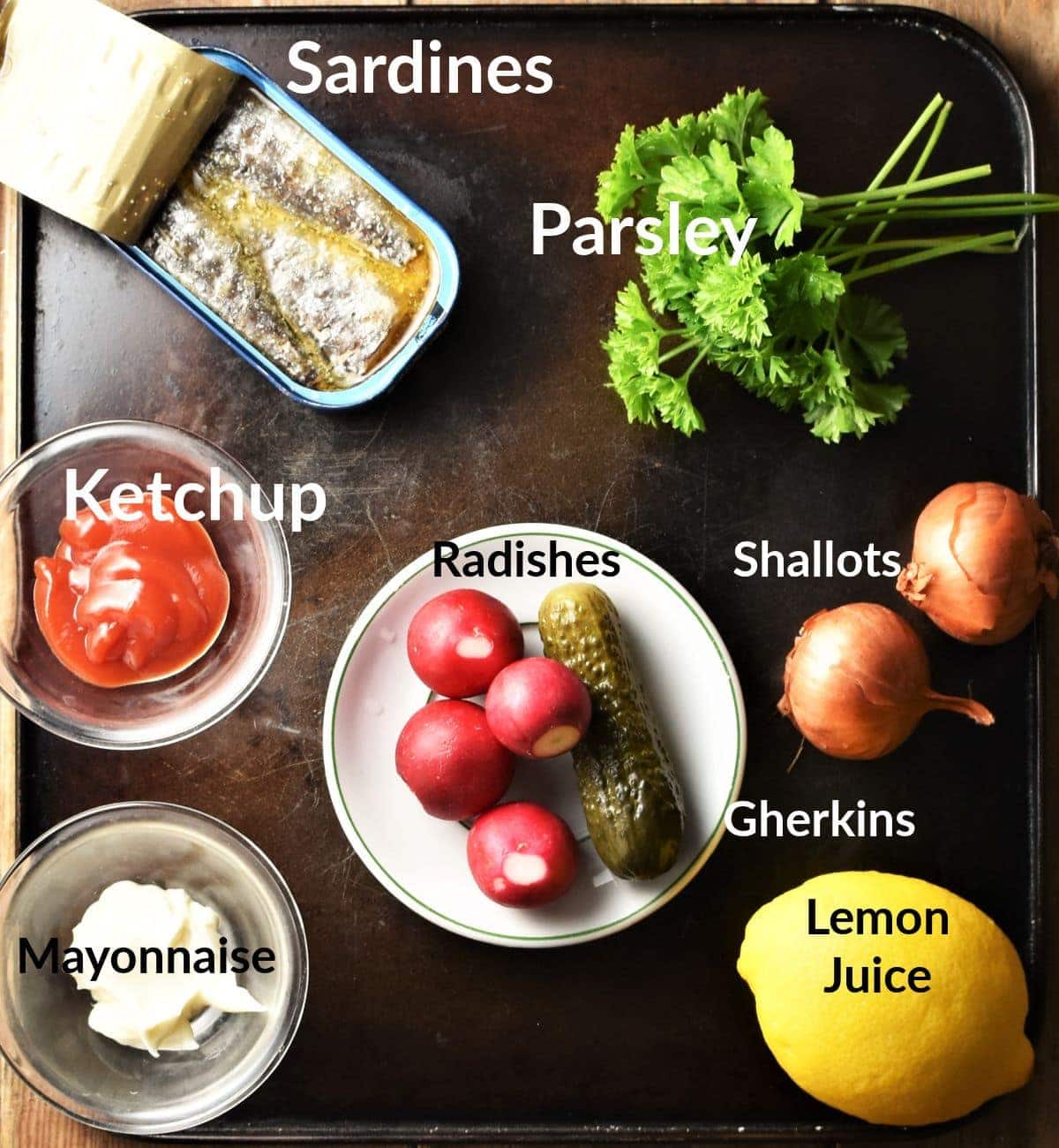 Ingredients for sardines on toast in individual dishes.