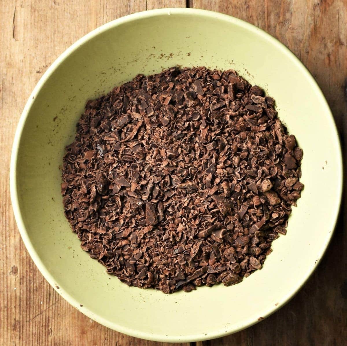 Chocolate shavings in yellow bowl.
