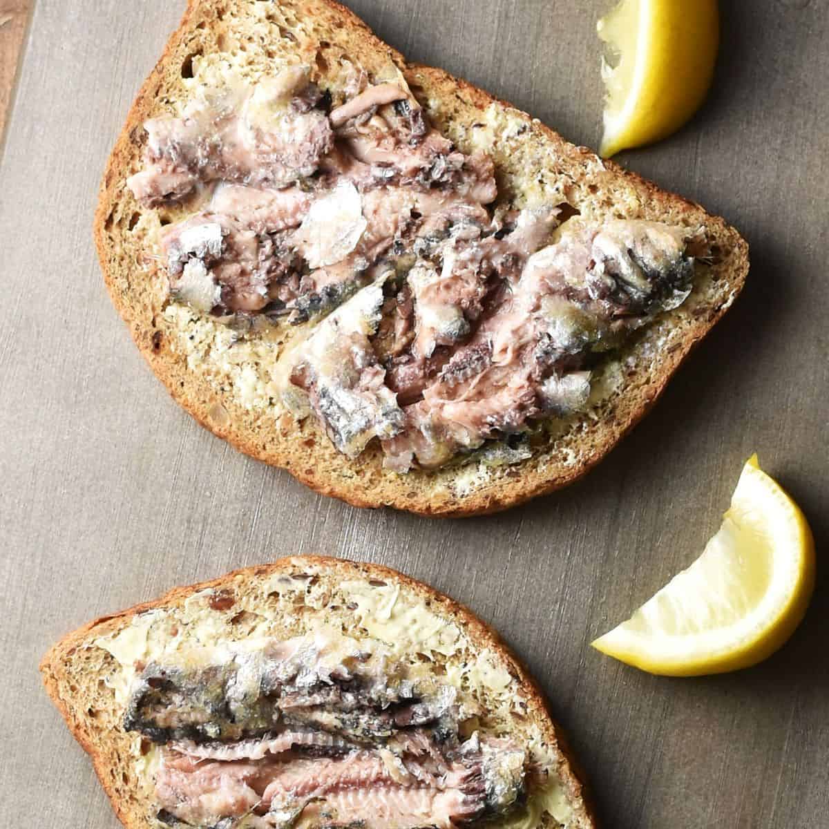 Top down view of smashed sardines on 2 slices of toast.