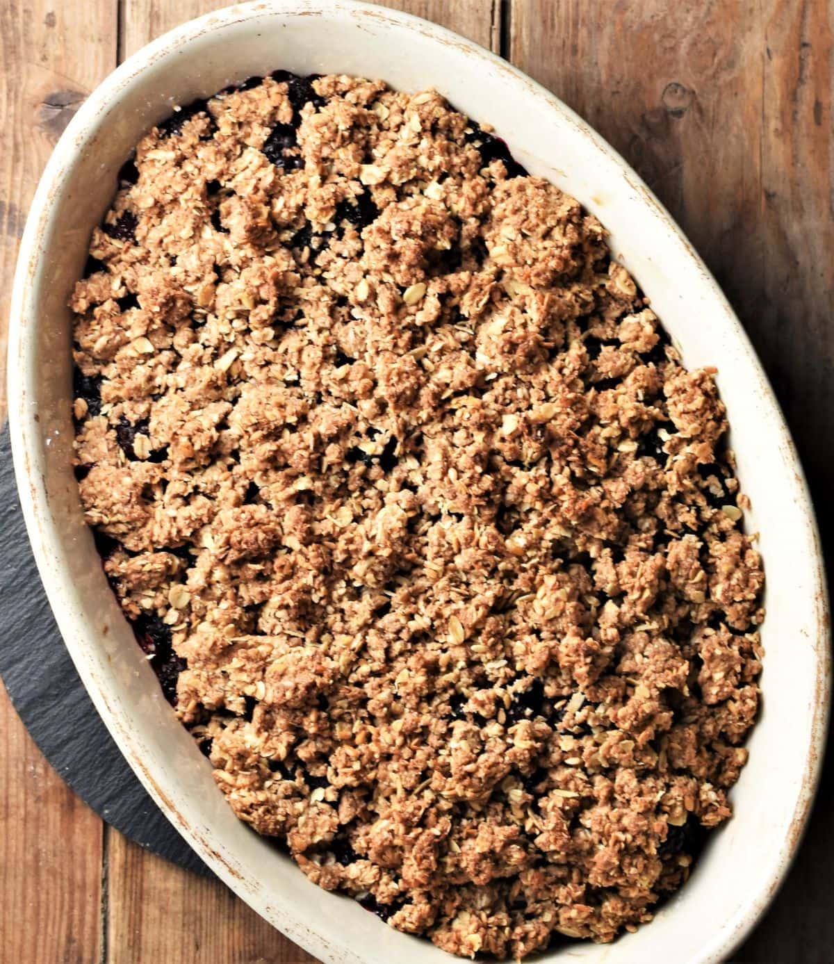 Top down view of crumble in oval white dish.