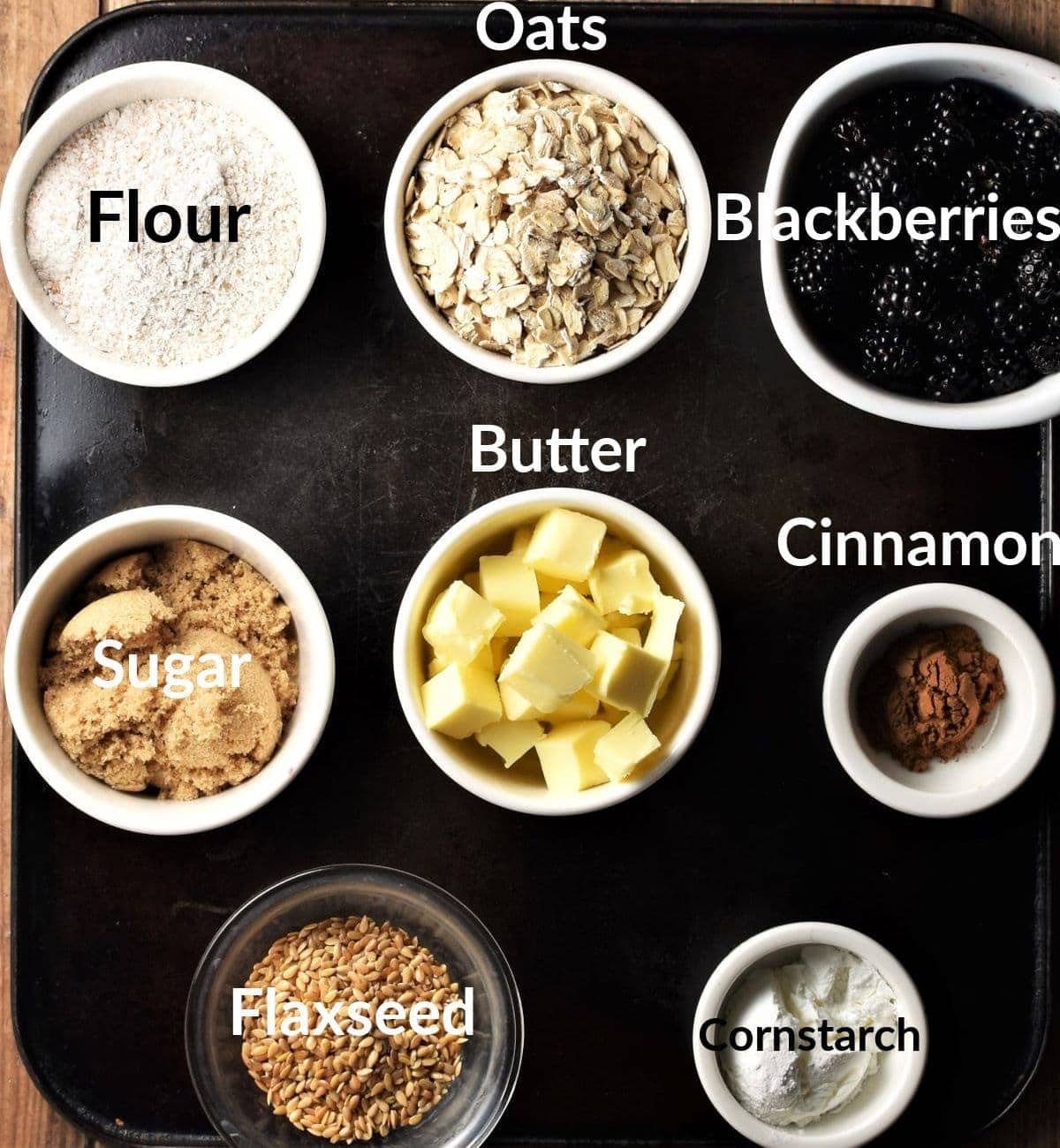 Blackberry crumble ingredients in individual dishes.