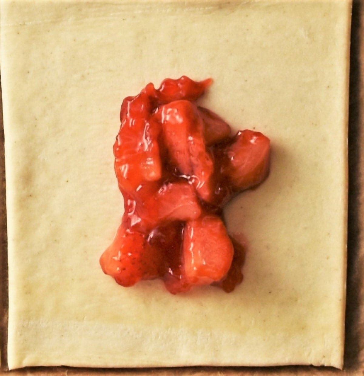 Pastry square with strawberry mixture in centre.