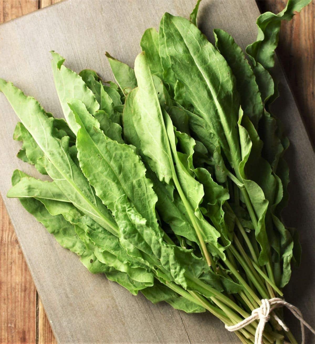 Sorrel leaves on top of grey board.