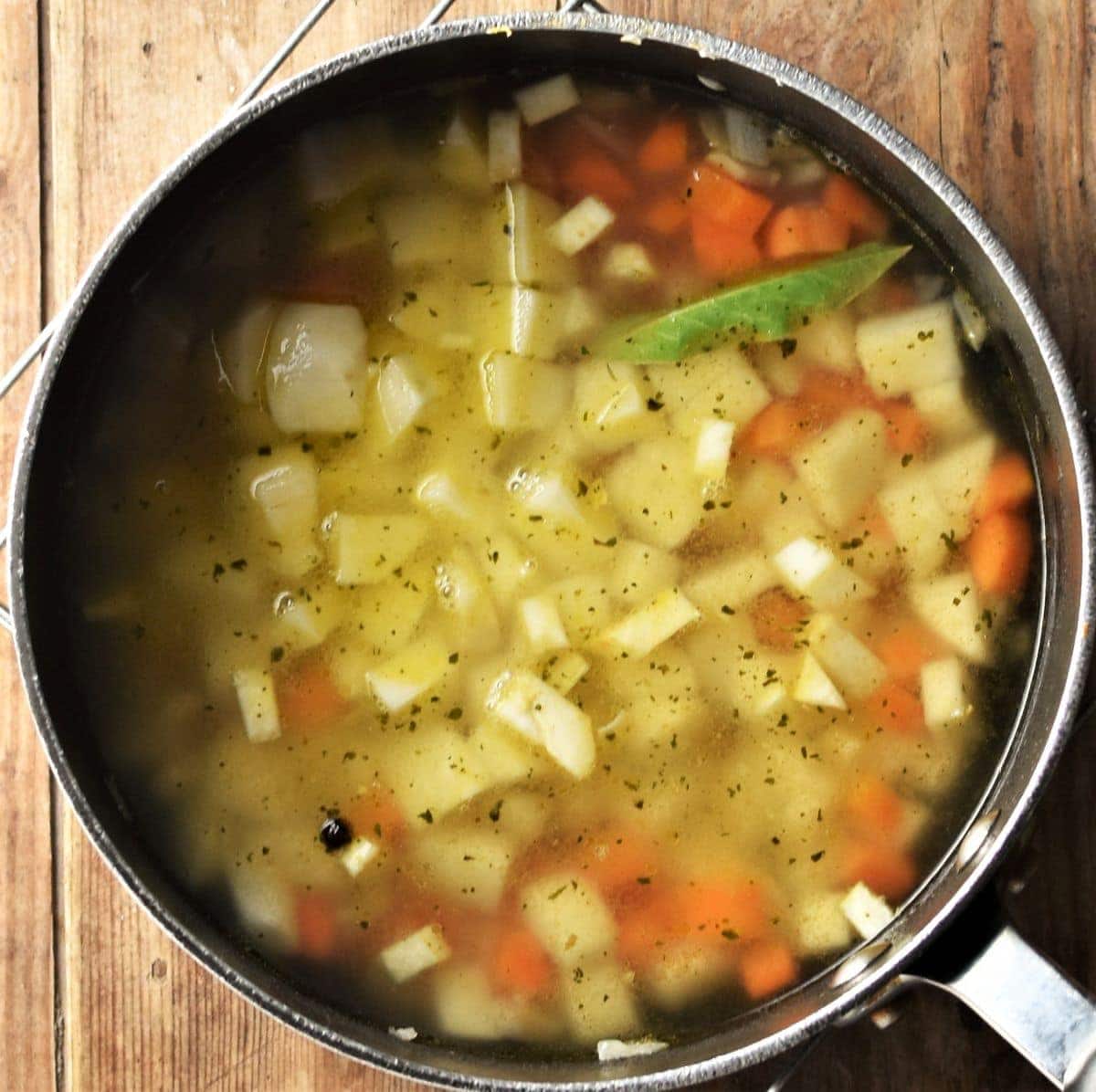 Chunky vegetable soup in large pot.