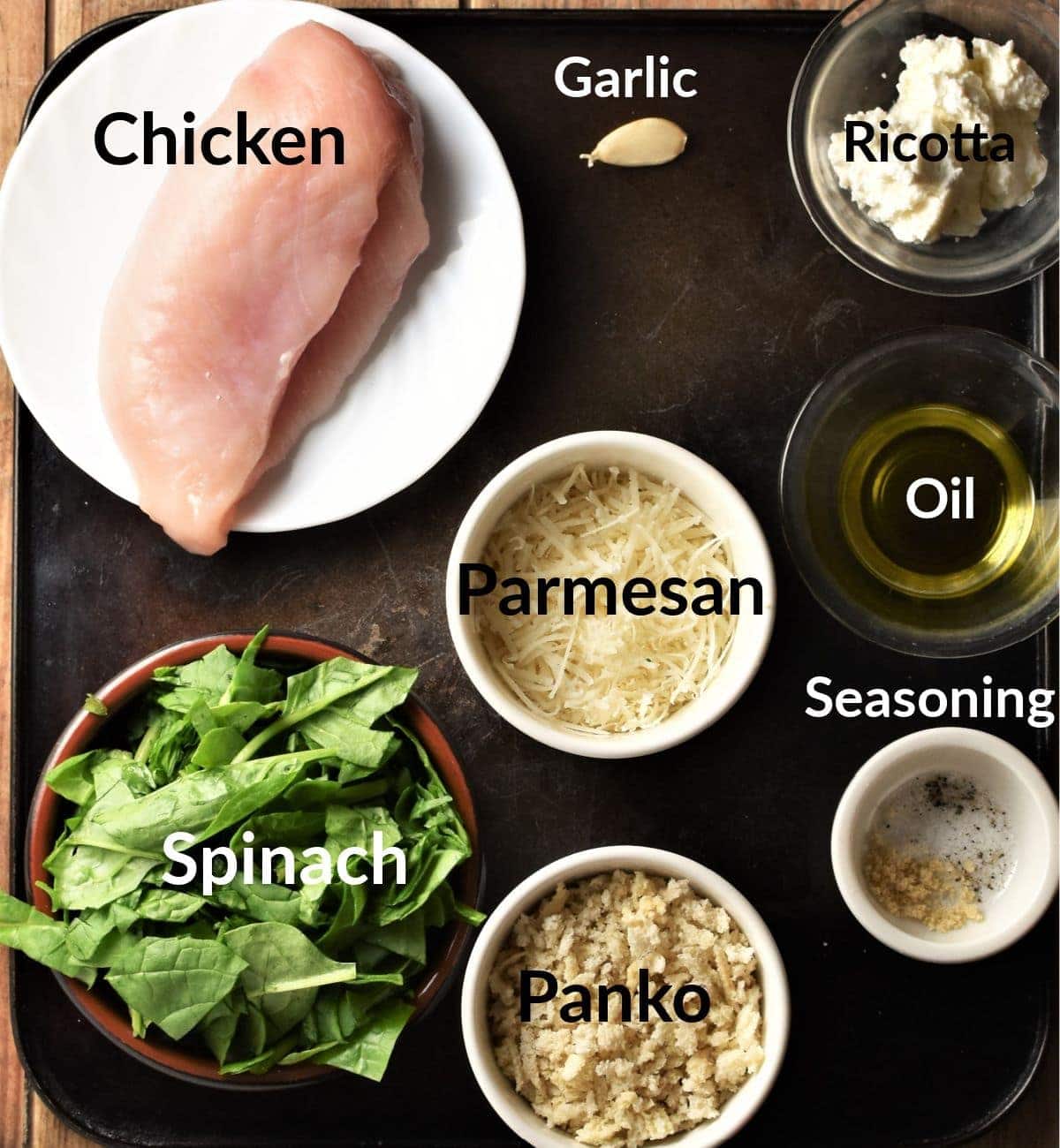Spinach and cheese chicken ingredients in individual dishes.