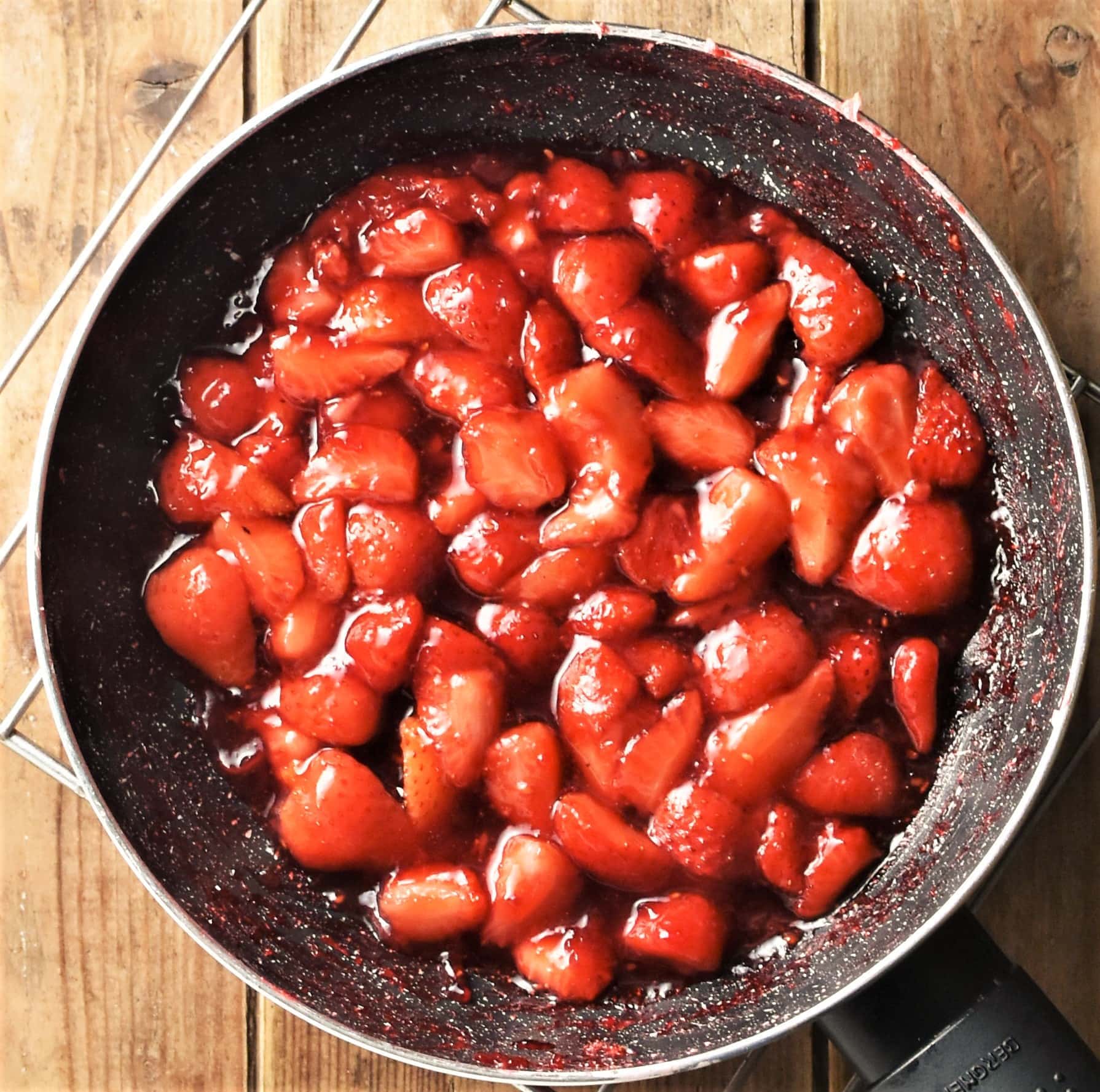 Cooked strawberries in pan.