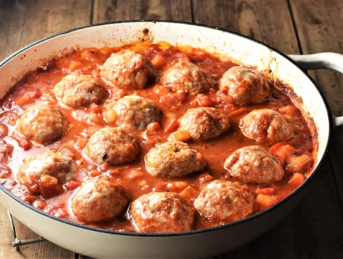 Meatball vegetable casserole in white shallow dish.