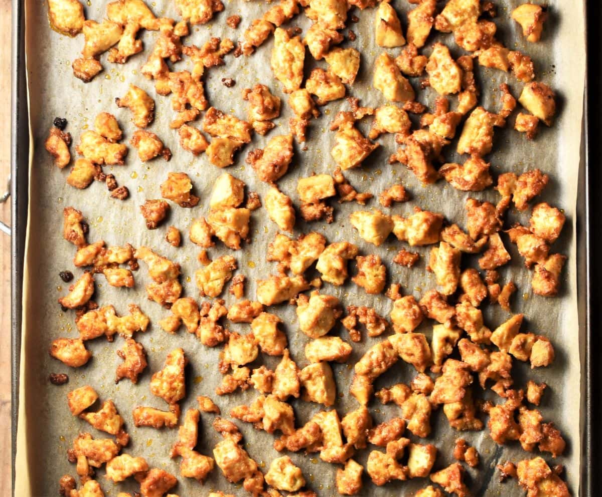 Baked crumbled tofu on top of parchment.